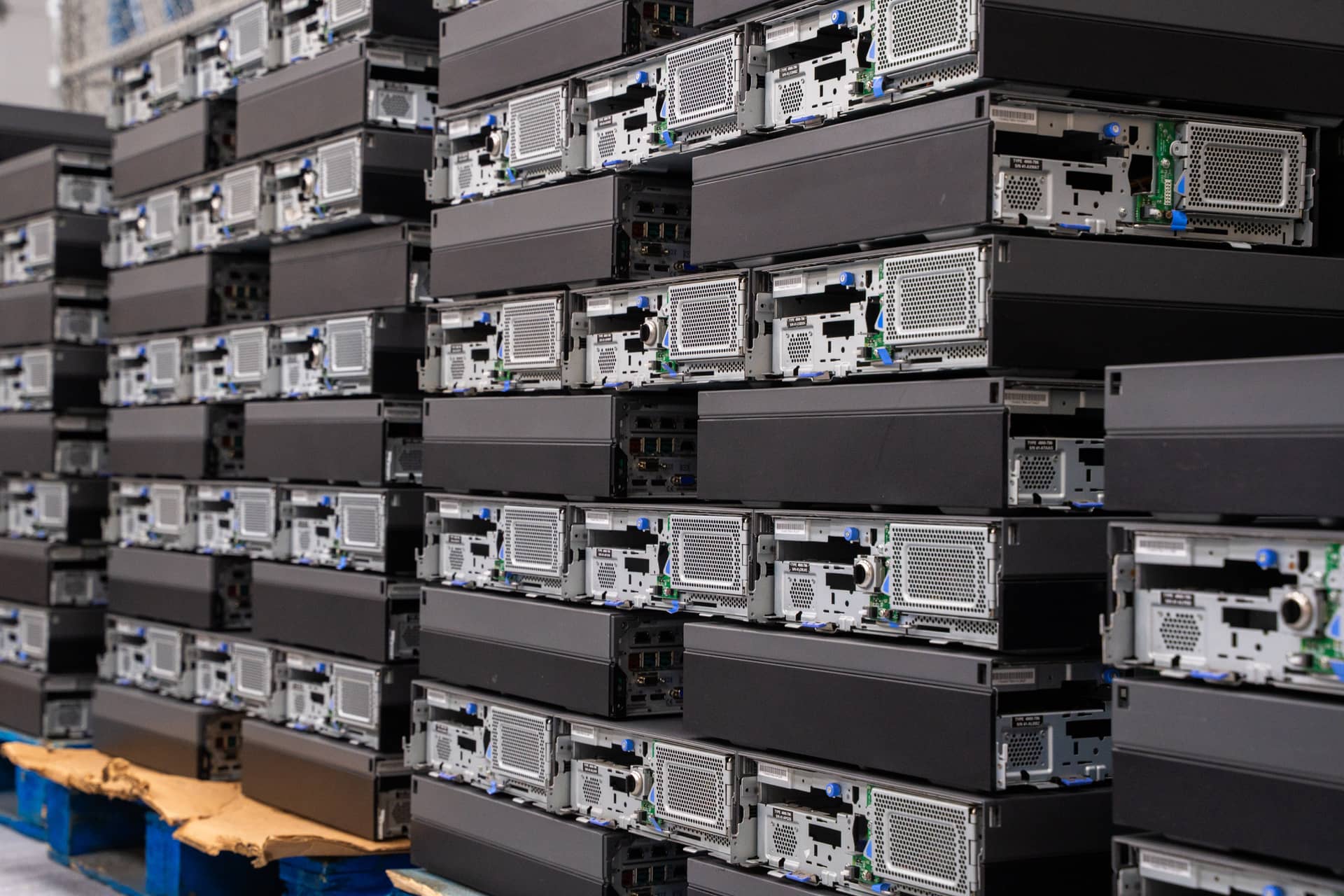 Stacks of de-installed computer servers organized on pallets, emphasizing discipline and avoiding costly mistakes in asset management.