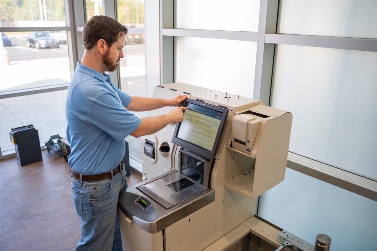 Technician assessing your POS device, highlighting hidden PCI risks when devices leave the store.
