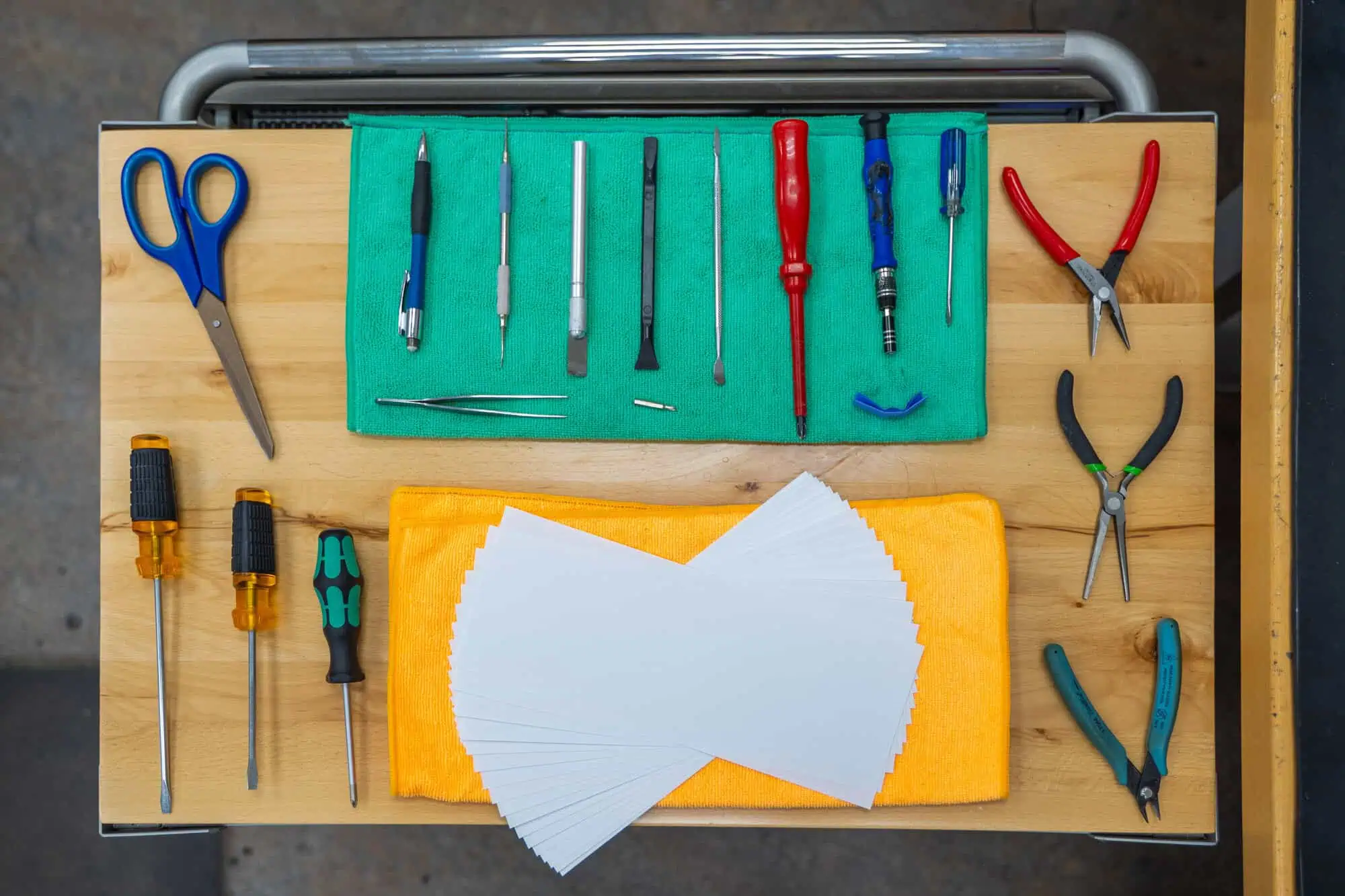 Assorted repair tools on a workbench for refurbish repair test services, emphasizing your technology investment.