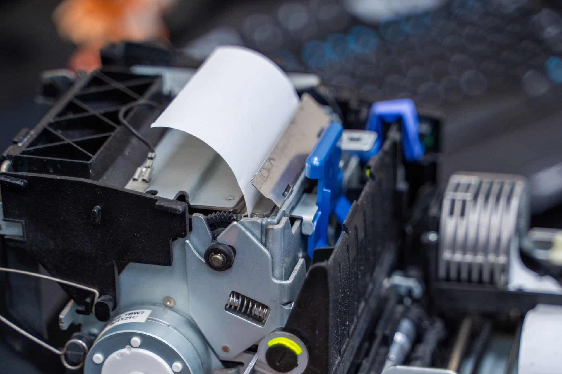 Printer with exposed internal components highlighting the seamless path in asset deployment programs.