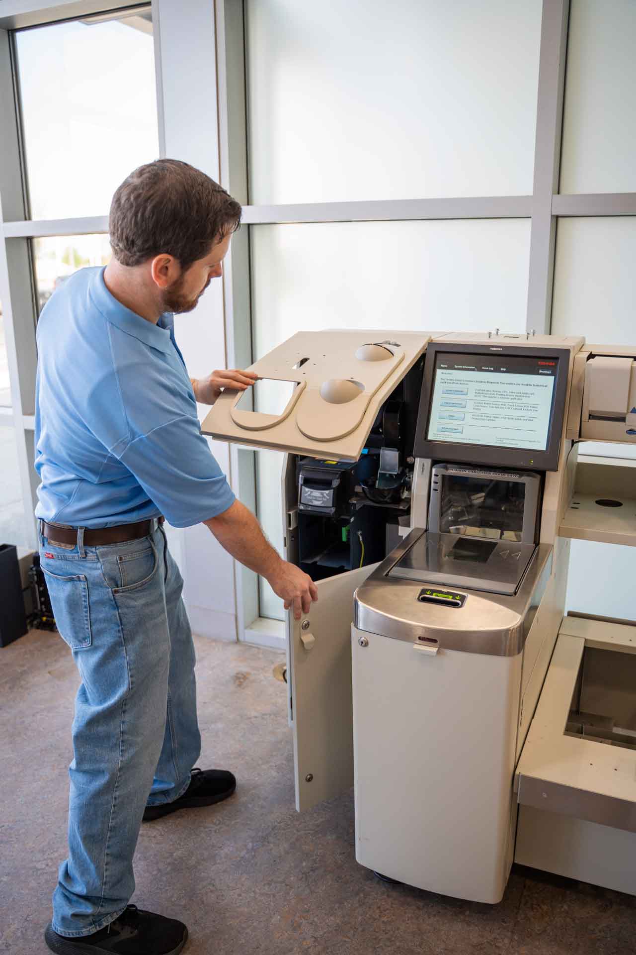 Technician adjusting hardware in retail, highlighting how the right choice avoids friction and downtime.
