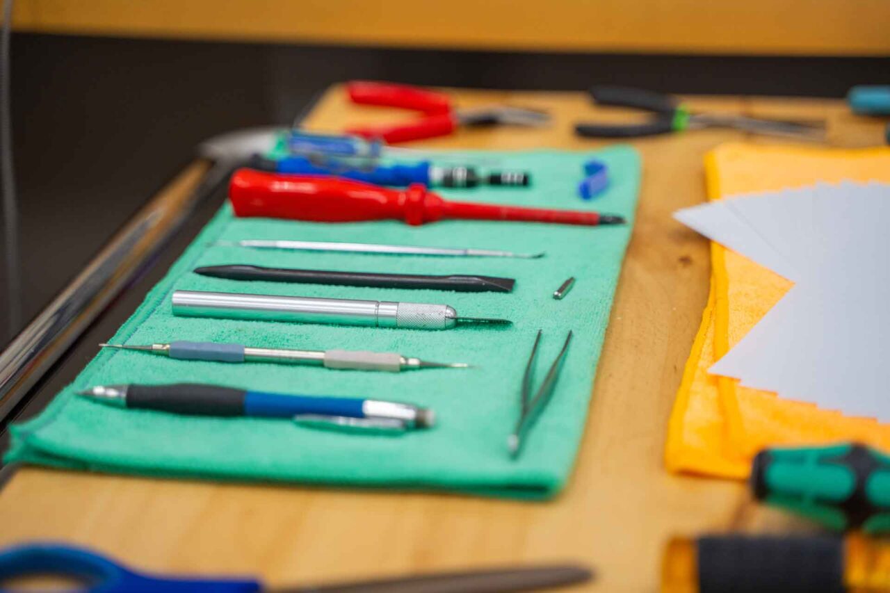Assorted tools on a wooden table, showcasing essential hardware for making the right purchasing decision.