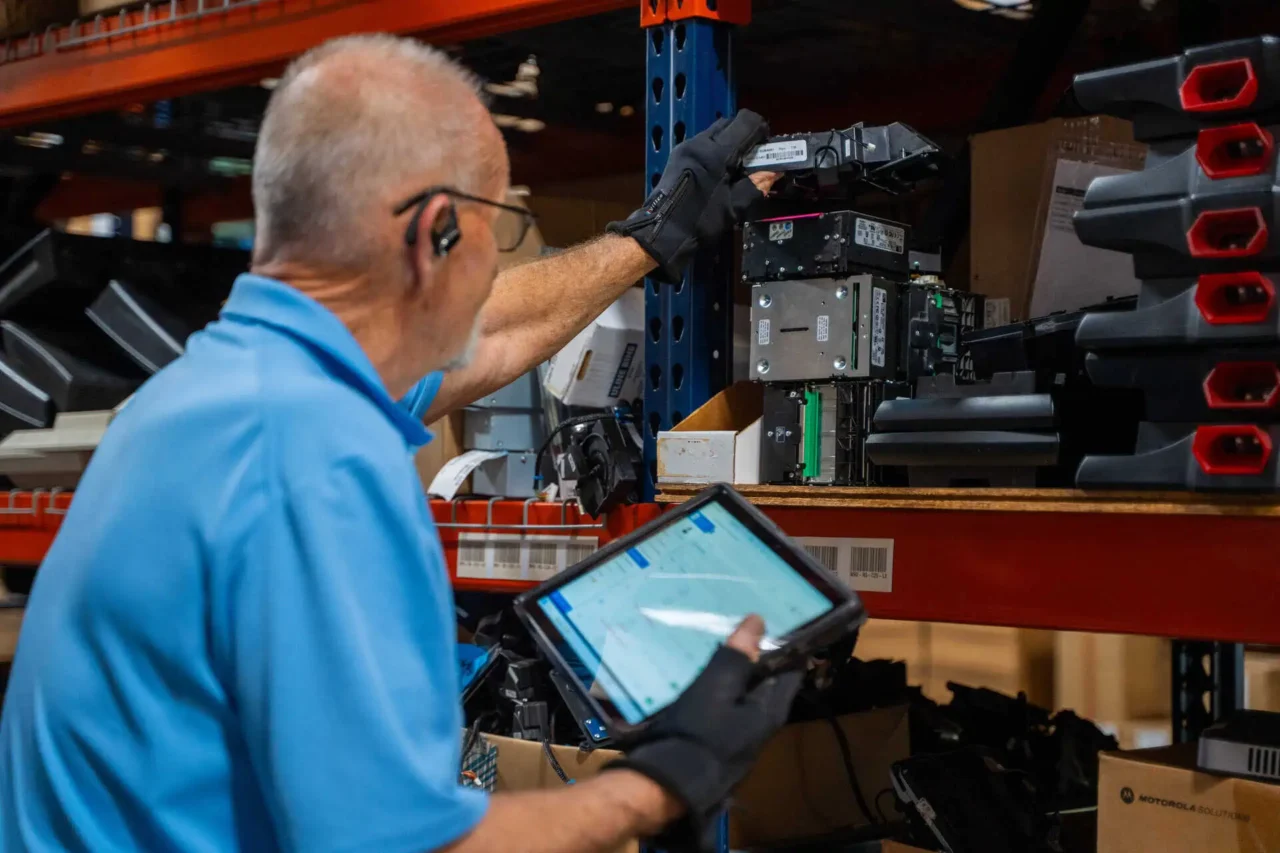Employee manages inventory with a tablet, enhancing operations for retail confidence in every location.