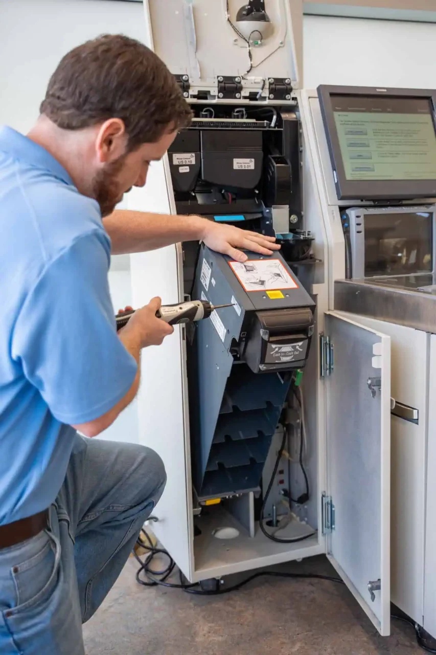 Technician maintaining a retail device, enhancing operations for every project, location, and device reach.